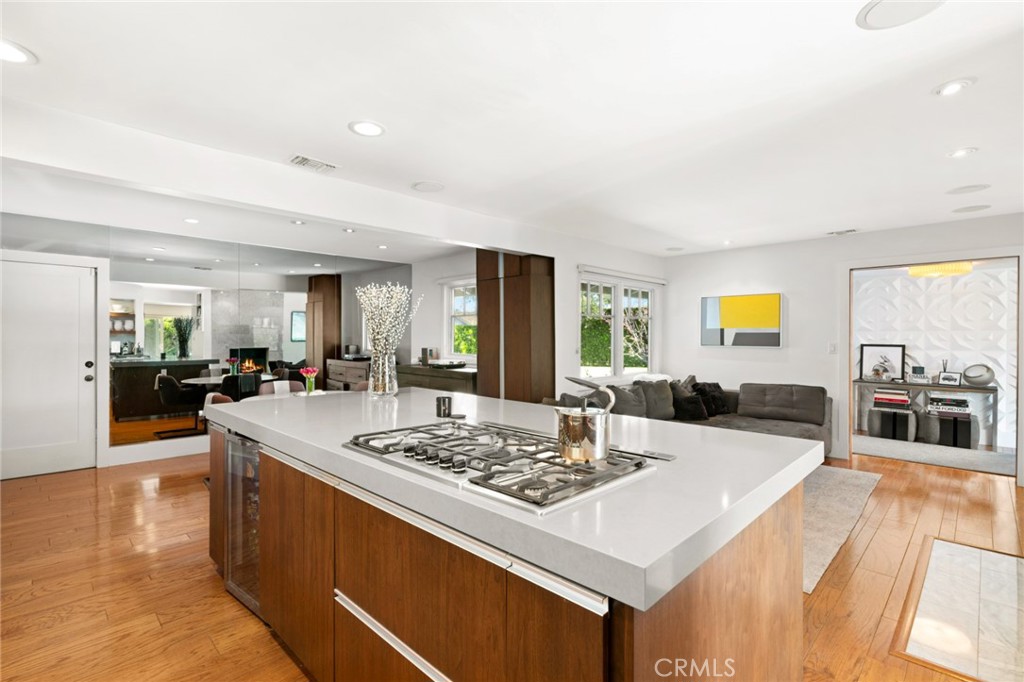 a living room with stainless steel appliances kitchen island granite countertop furniture and a fireplace