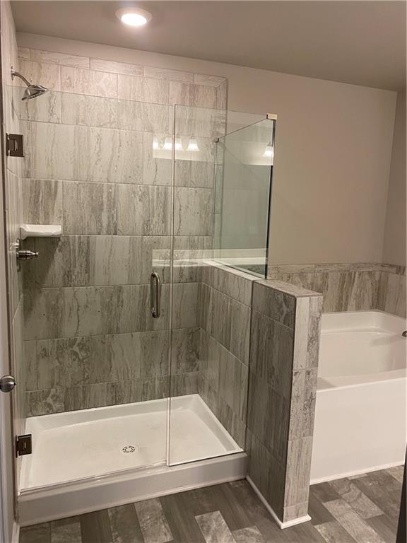 5282 Fox Den Road Oakwood, GA 30566 - Photo 3 of 14 a bathroom with a bathtub and a shower