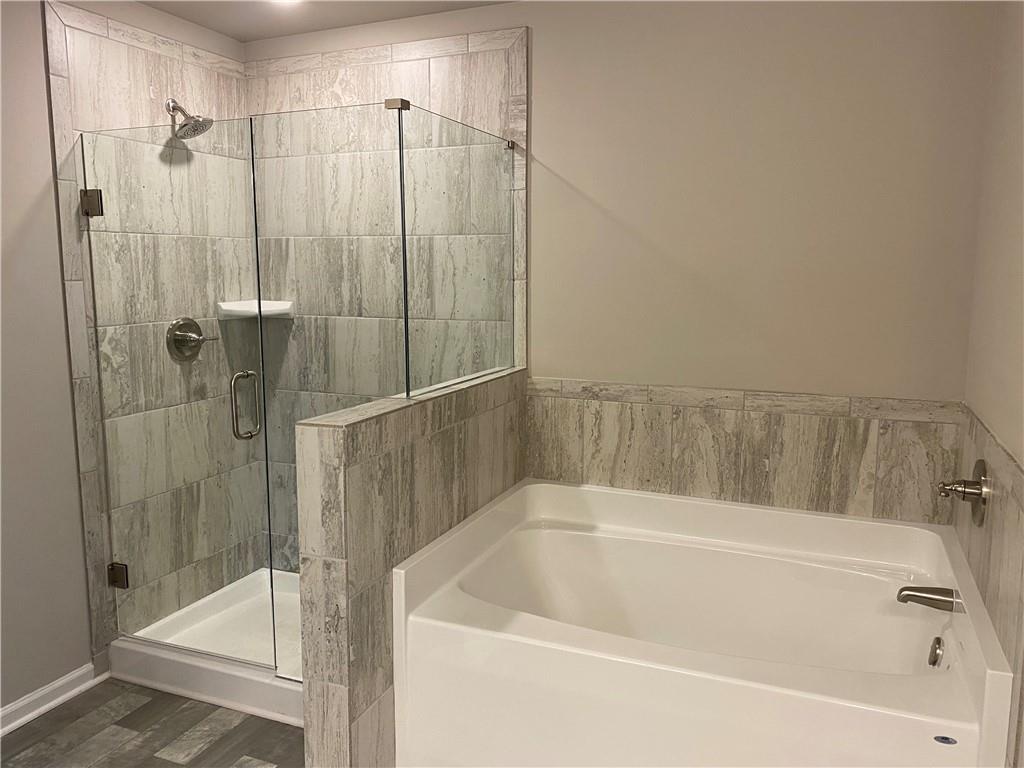 5282 Fox Den Road Oakwood, GA 30566 - Photo 5 of 14 a white bath tub sitting next to a shower
