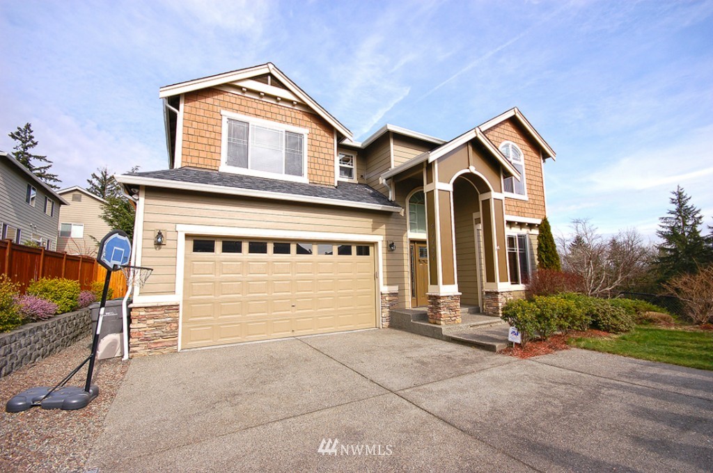 21107 1st Avenue West Bothell, WA 98021 - Photo 1 of 20 a front view of a house with a yard and garage
