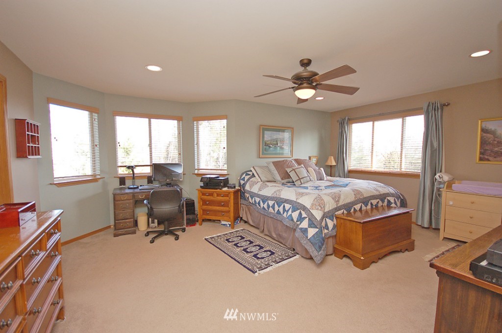 21107 1st Avenue West Bothell, WA 98021 - Photo 13 of 20 a bedroom with a bed and a table in it with window