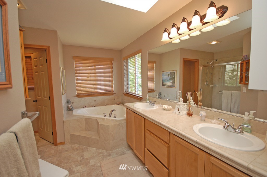 21107 1st Avenue West Bothell, WA 98021 - Photo 15 of 20 a spacious bathroom with a tub double sink and mirror