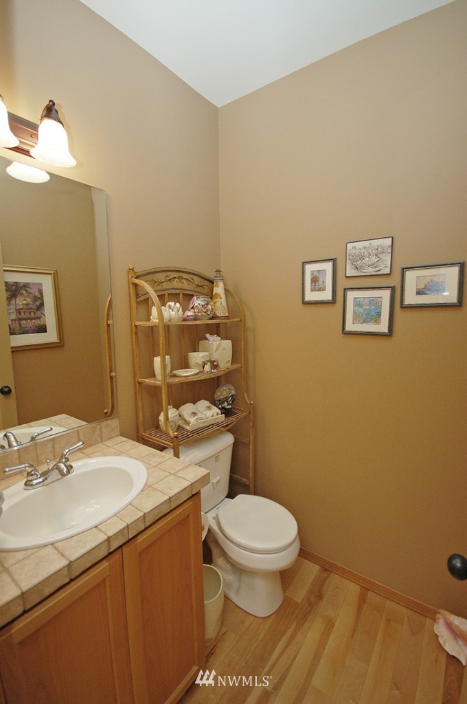 21107 1st Avenue West Bothell, WA 98021 - Photo 4 of 20 a bathroom with a granite countertop toilet sink and mirror
