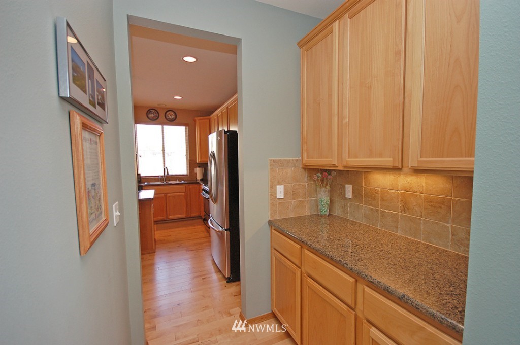 21107 1st Avenue West Bothell, WA 98021 - Photo 5 of 20 a kitchen with stainless steel appliances granite countertop a refrigerator and a sink