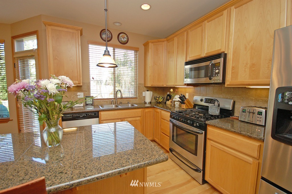 21107 1st Avenue West Bothell, WA 98021 - Photo 6 of 20 a kitchen with stainless steel appliances granite countertop a stove a sink and a microwave