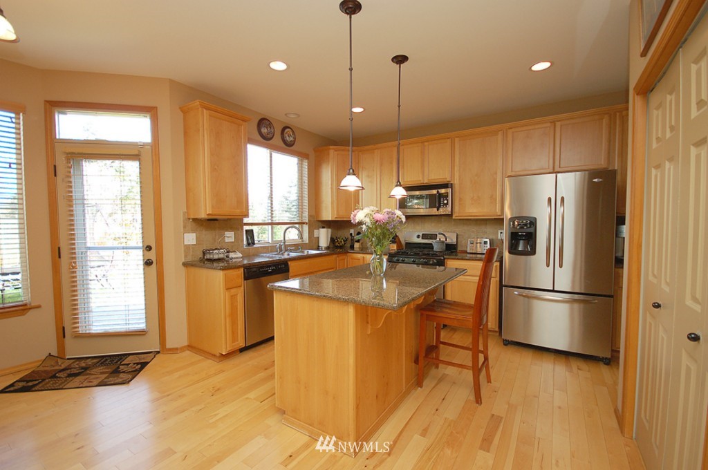 21107 1st Avenue West Bothell, WA 98021 - Photo 7 of 20 a kitchen with stainless steel appliances granite countertop a refrigerator a stove a sink and a microwave