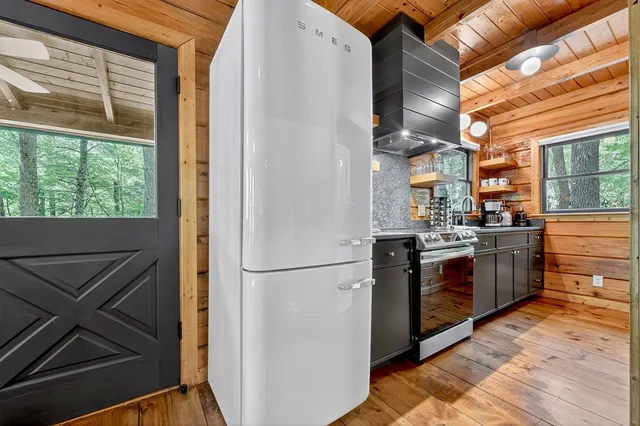 a kitchen with stainless steel appliances granite countertop a refrigerator and a stove