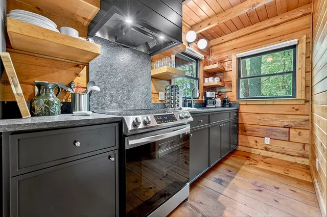 a kitchen with stainless steel appliances granite countertop a sink and a stove