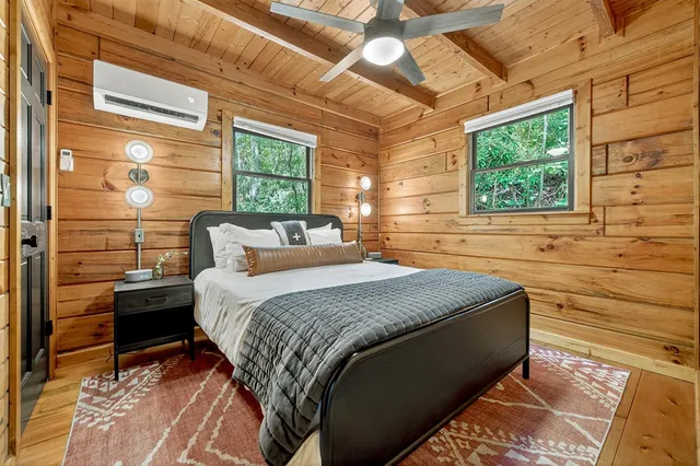 a bedroom with a bed and a window