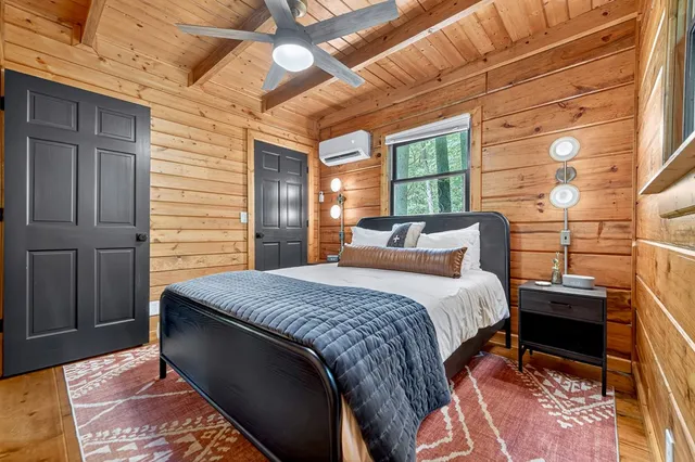 a bed sitting in a bedroom next to a window