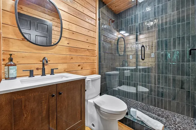 a bathroom with a sink a toilet and a mirror