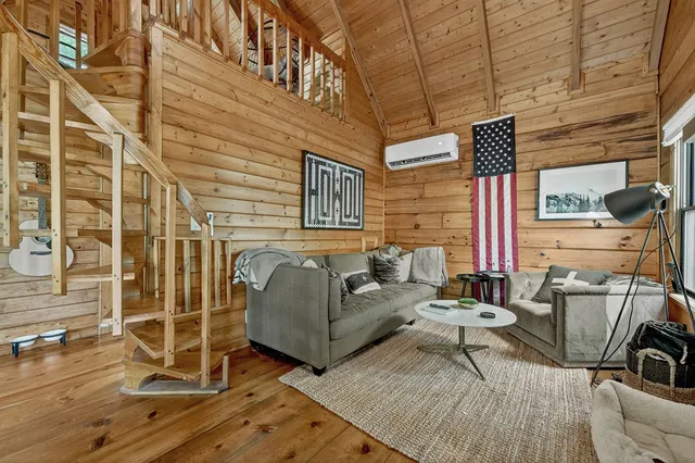 a view of a patio with couches chairs and wooden floor