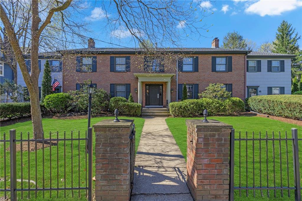 a front view of a house with a garden