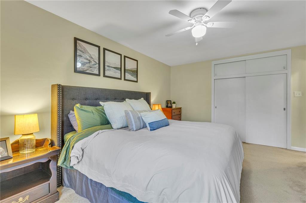610 Maple Lane, Unit 1 Sewickley, PA 15143 - Photo 14 of 31 a bedroom with a bed and a chandelier