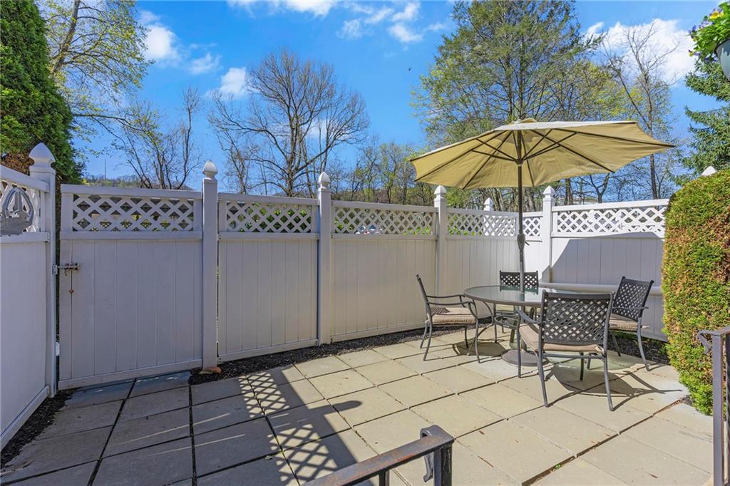 610 Maple Lane, Unit 1 Sewickley, PA 15143 - Photo 19 of 31 a view of a patio with a table and chairs under an umbrella