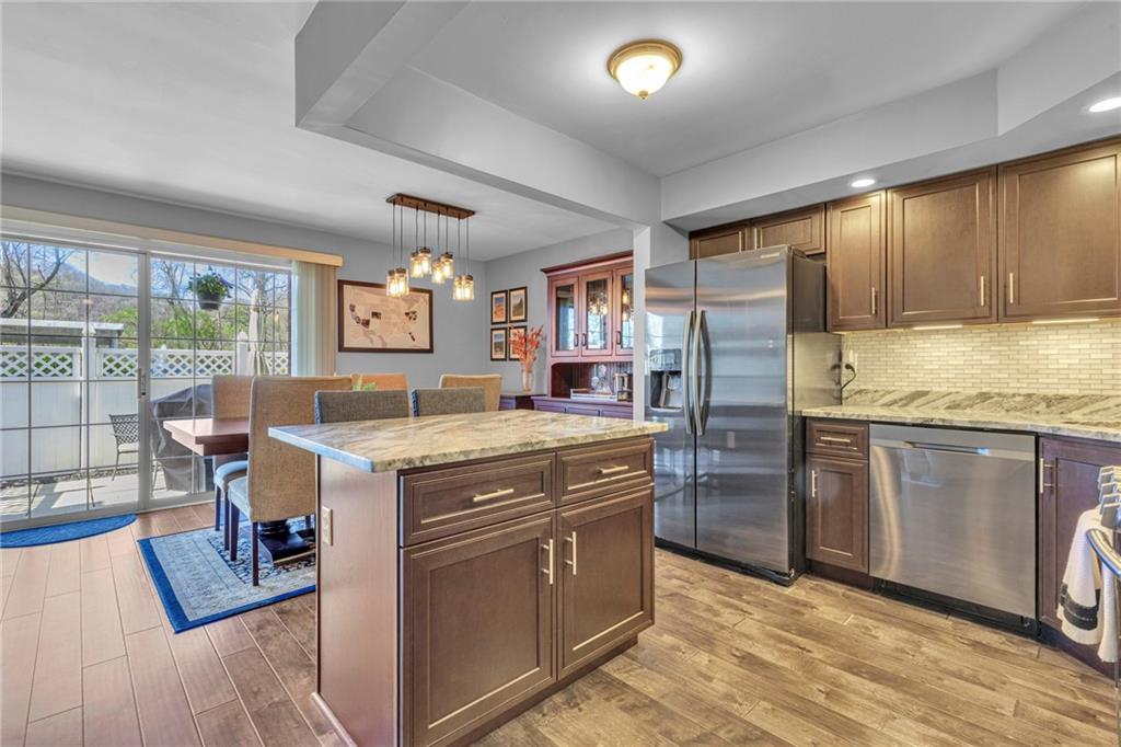 610 Maple Lane, Unit 1 Sewickley, PA 15143 - Photo 2 of 31 a kitchen with a stove a refrigerator and wooden cabinets
