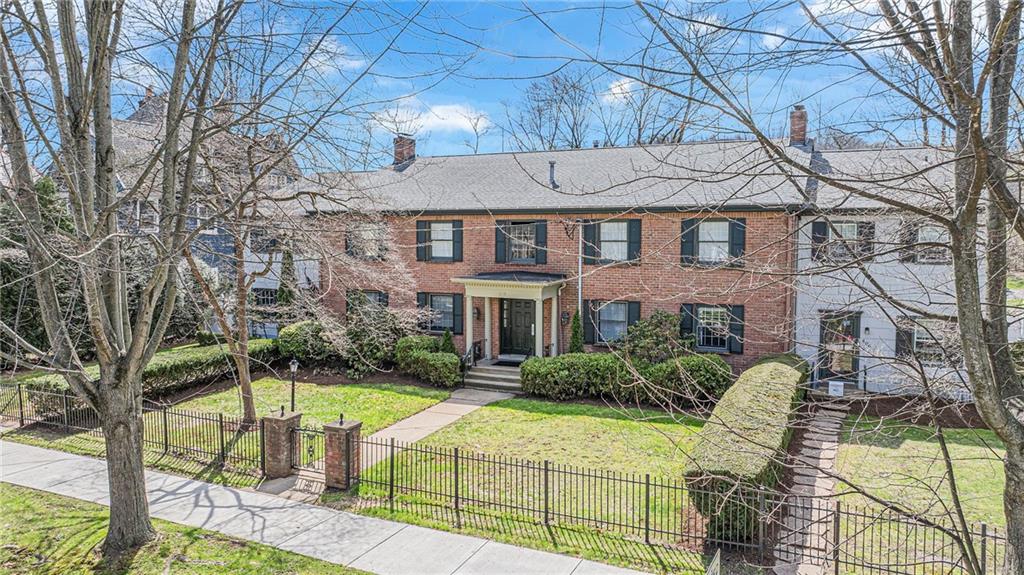610 Maple Lane, Unit 1 Sewickley, PA 15143 - Photo 23 of 31 a view of a brick house with large windows and a table and chairs