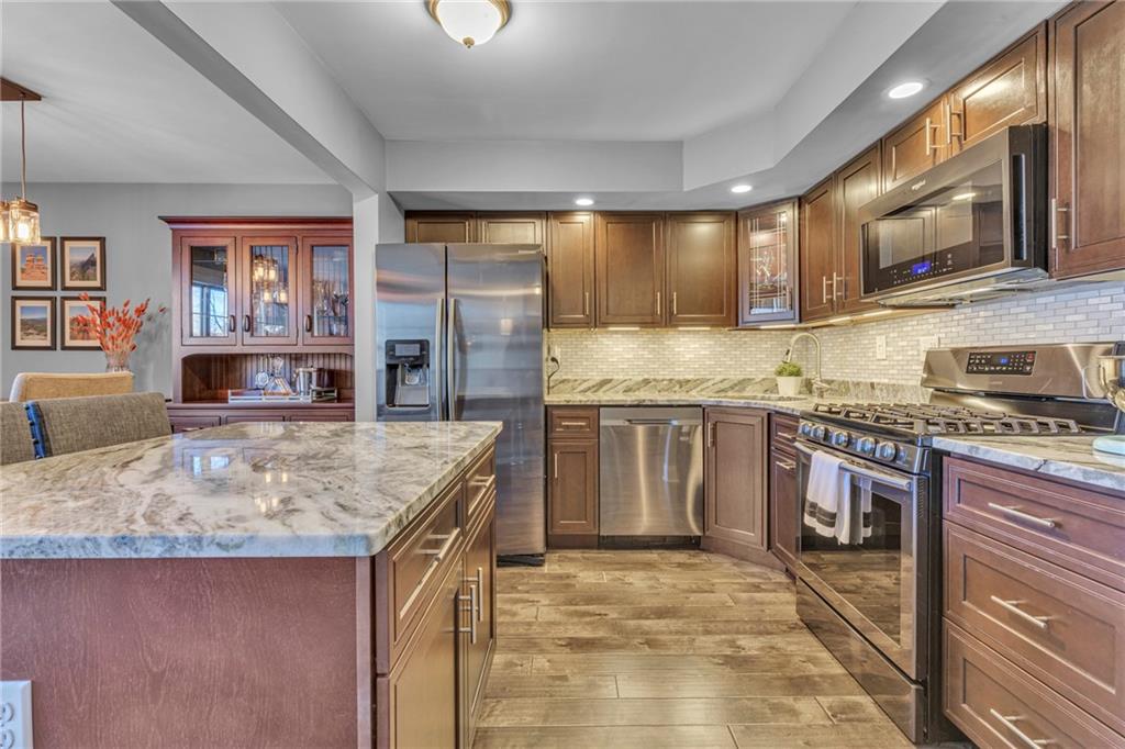 610 Maple Lane, Unit 1 Sewickley, PA 15143 - Photo 3 of 31 a kitchen with stainless steel appliances granite countertop a sink stove and refrigerator