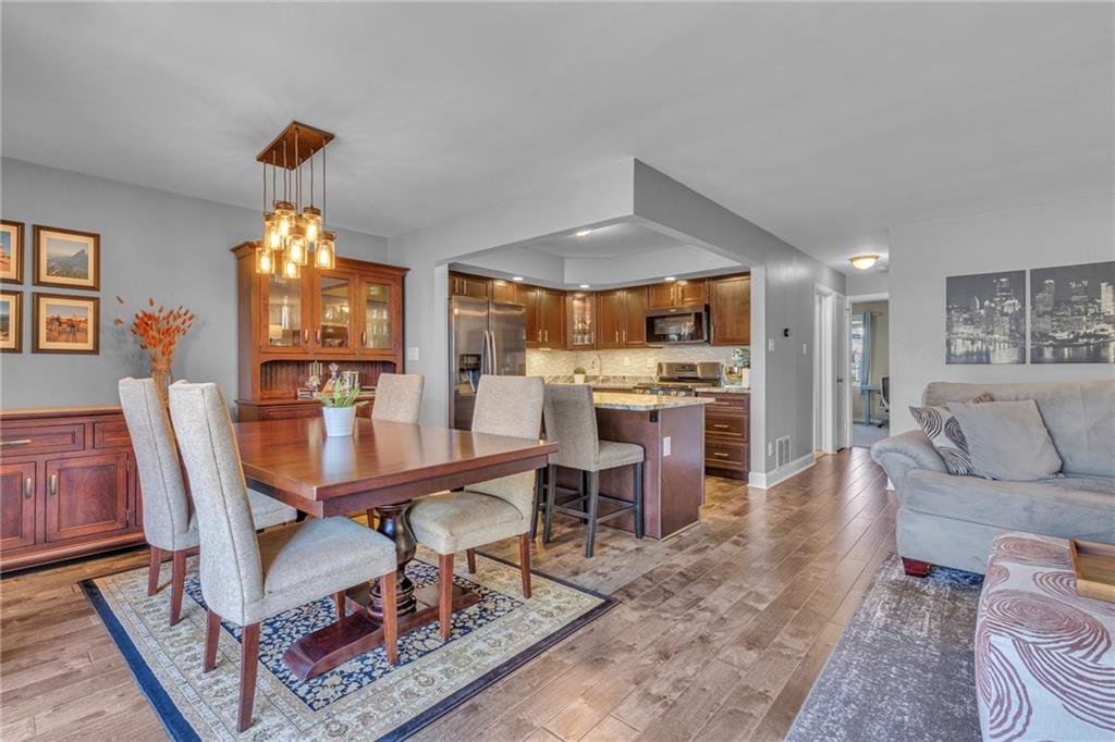 610 Maple Lane, Unit 1 Sewickley, PA 15143 - Photo 5 of 31 a living room with furniture a dining table and a chandelier