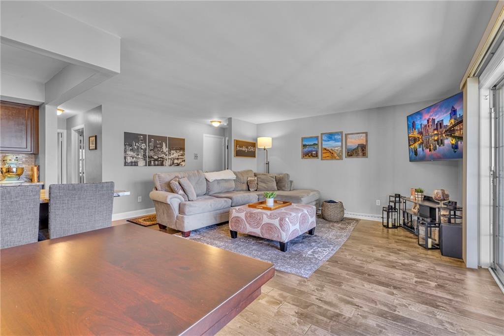 610 Maple Lane, Unit 1 Sewickley, PA 15143 - Photo 6 of 31 a living room with furniture and a flat screen tv