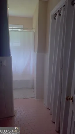 a bathroom with a glass shower door