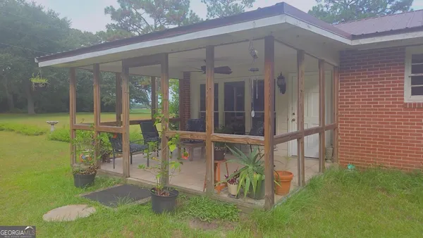 a view of a porch with a table and chairs