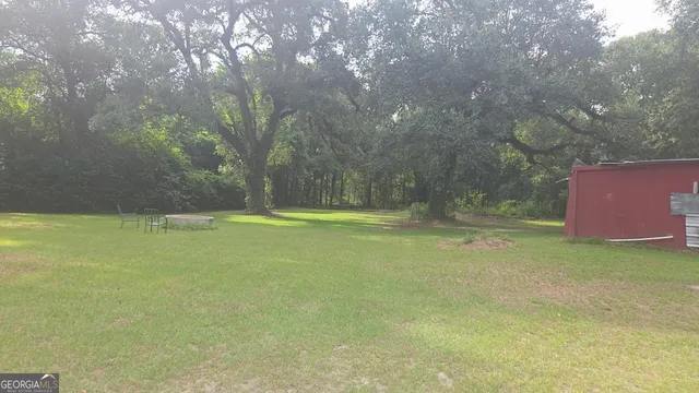 a view of outdoor space with deck and yard