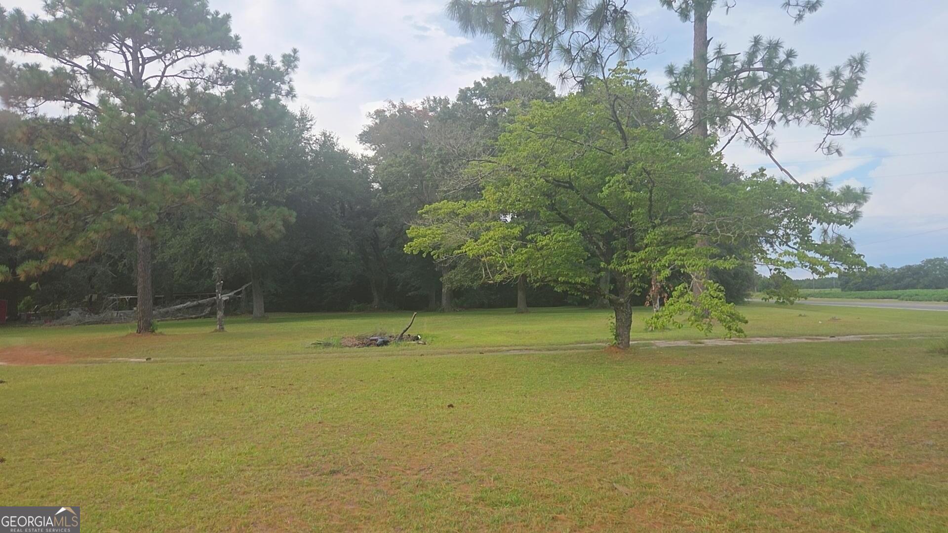 8468 Branchville Road Camilla, GA 31730 - Photo 20 of 22 a view of a swimming pool with an outdoor space and seating area
