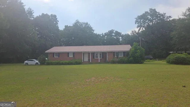 a view of a house next to a big yard