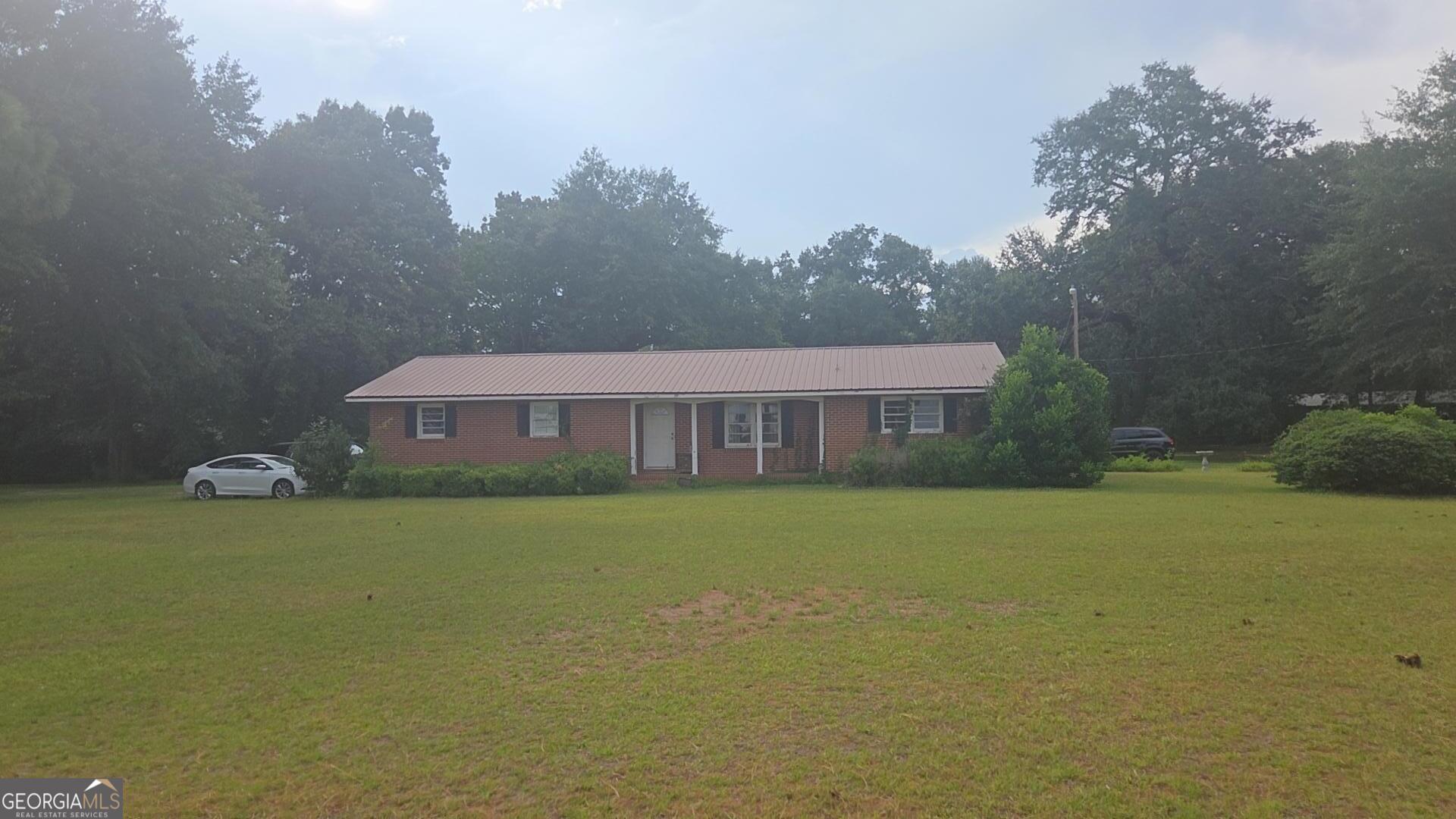 8468 Branchville Road Camilla, GA 31730 - Photo 2 of 22 a view of a house next to a big yard