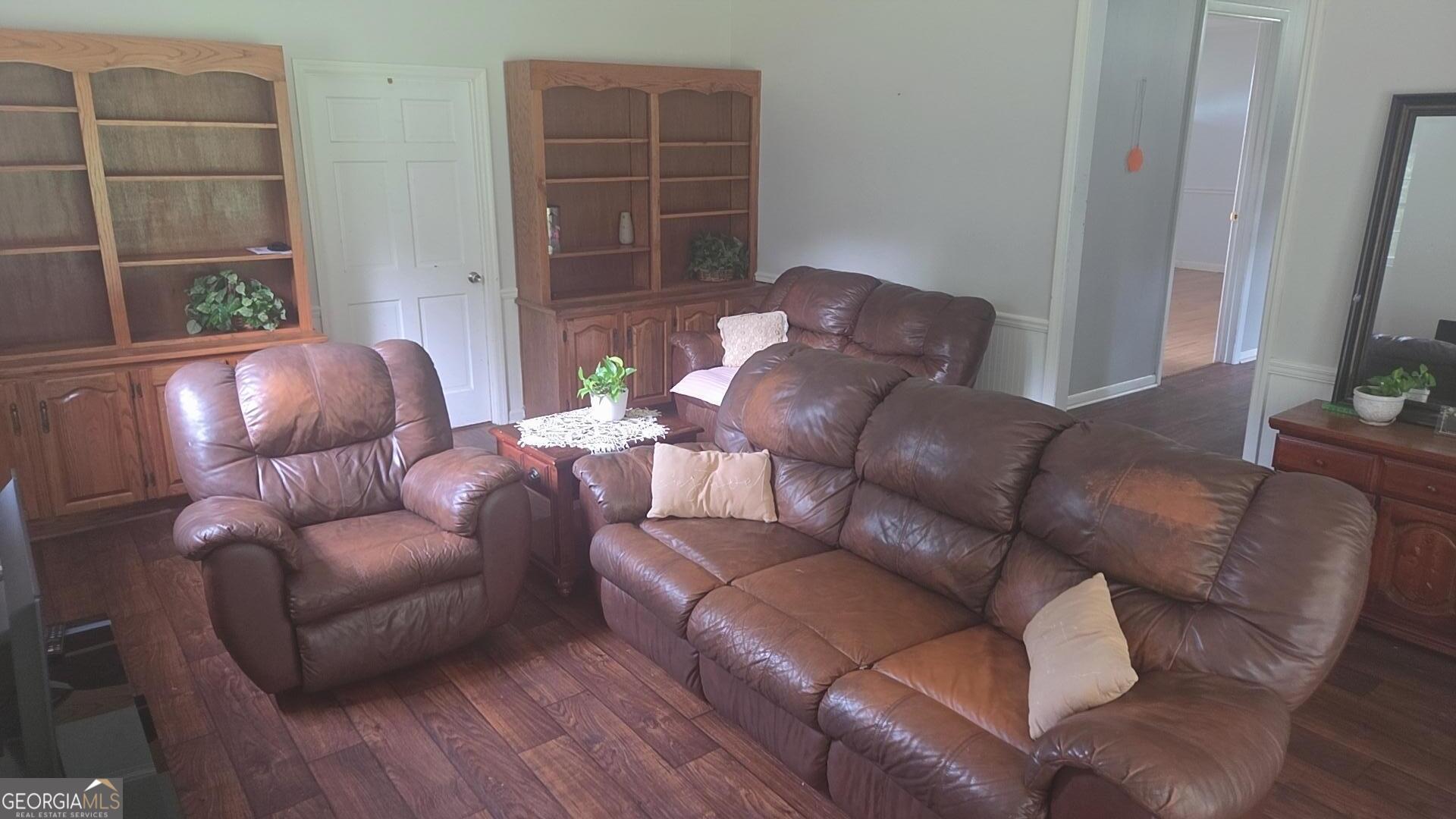 8468 Branchville Road Camilla, GA 31730 - Photo 7 of 22 a living room with furniture and a flat screen tv