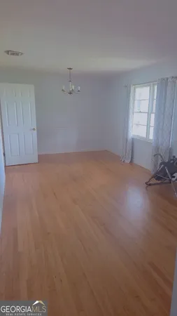 a view of an empty room and a window