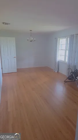 a view of an empty room and a window