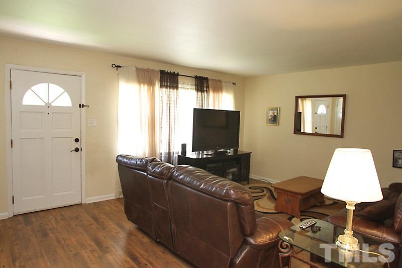 4706 Revere Road Durham, NC 27713 - Photo 2 of 13 a living room with furniture and a flat screen tv
