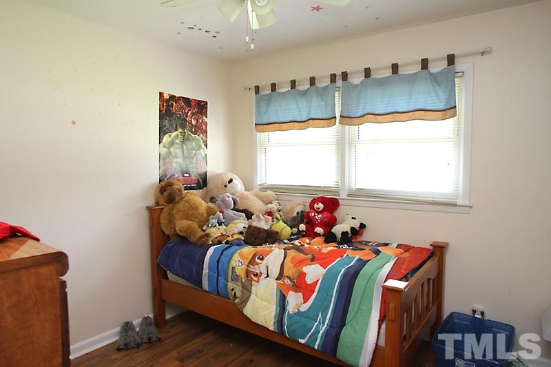 4706 Revere Road Durham, NC 27713 - Photo 7 of 13 a bedroom with bed and a window