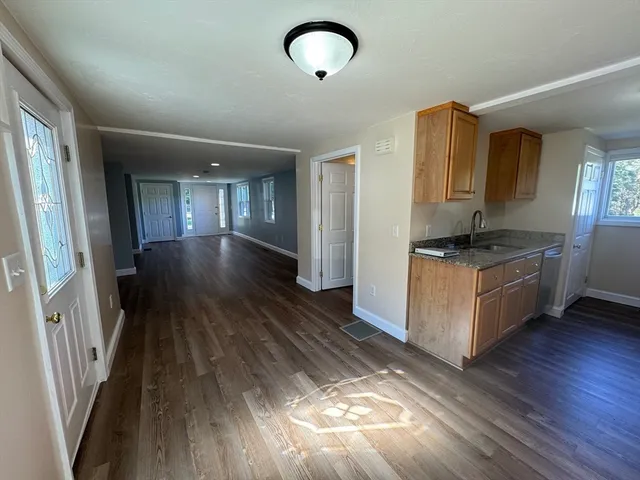 a view of kitchen and hall with wooden floor