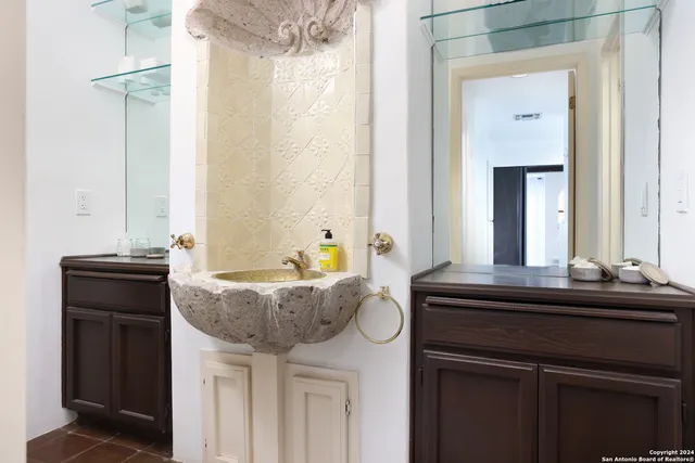 a bathroom with a granite countertop sink mirror and shower