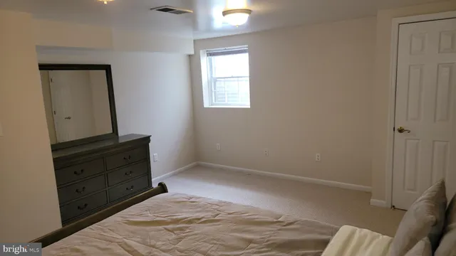 a room with a bed and a mirror