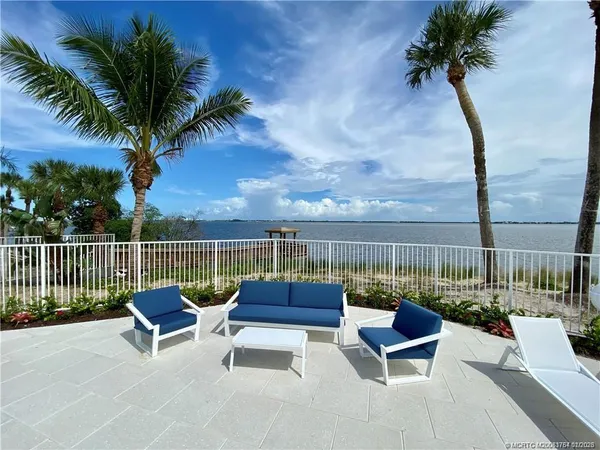 a view of a swimming pool with outdoor seating