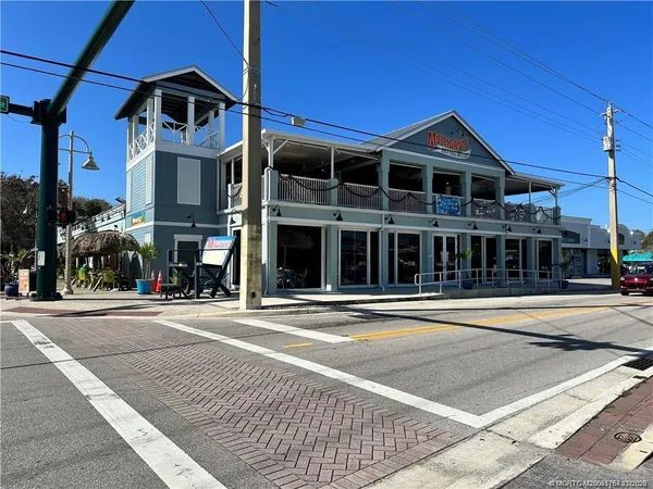 a view of a street with cars parked
