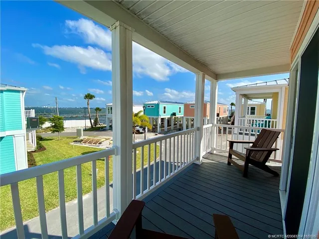 a living room with furniture flat screen tv and wooden floor