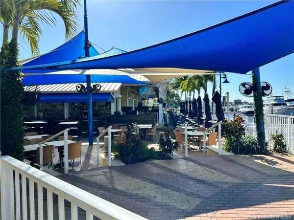 a view of a ocean with boats and trees in the background