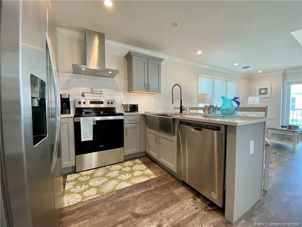 a kitchen with stainless steel appliances granite countertop a stove top oven a sink and dishwasher