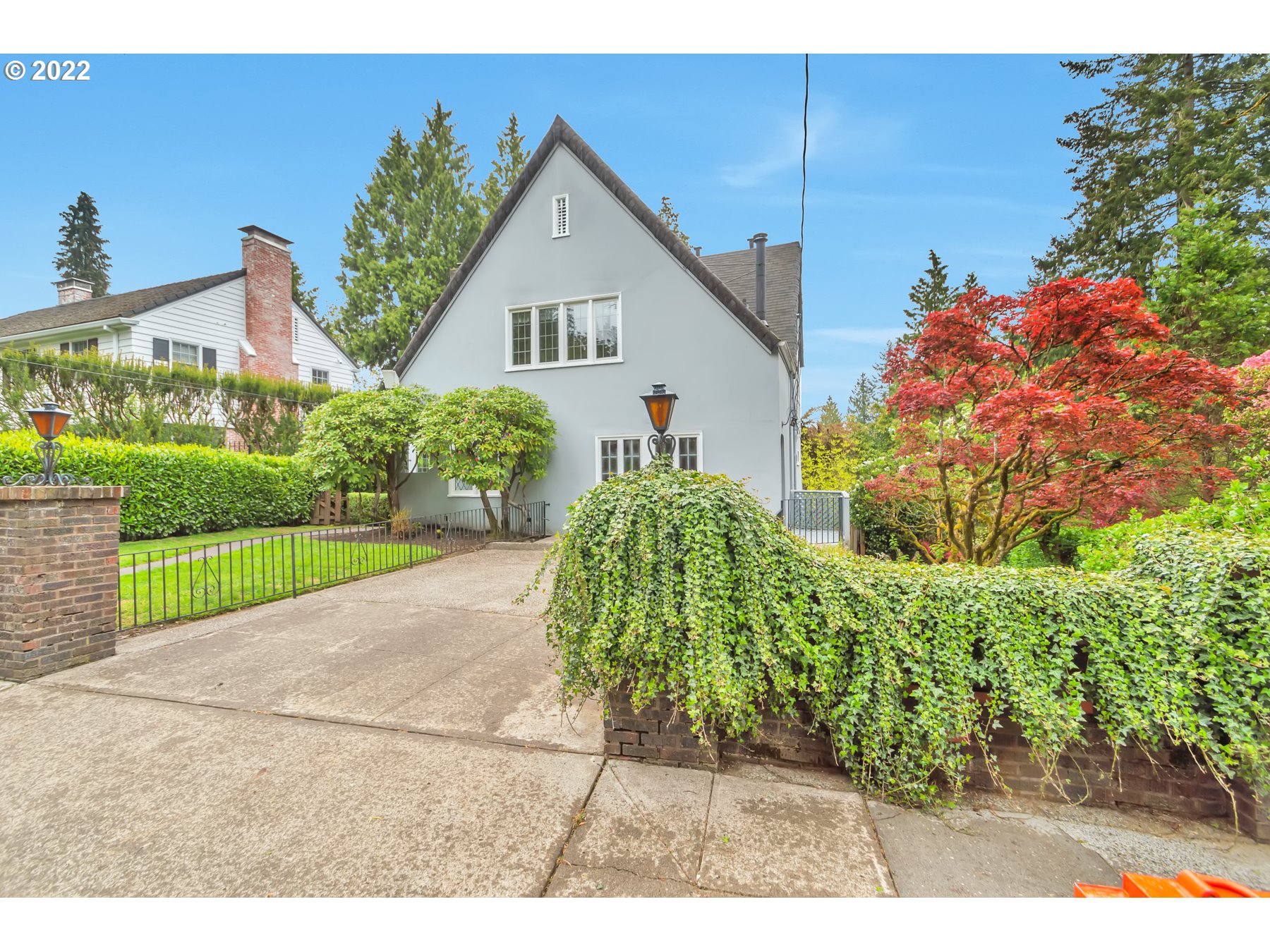 2430 Southwest Arden Road Portland, OR 97201 - Photo 3 of 32 a front view of a house with a yard and garage