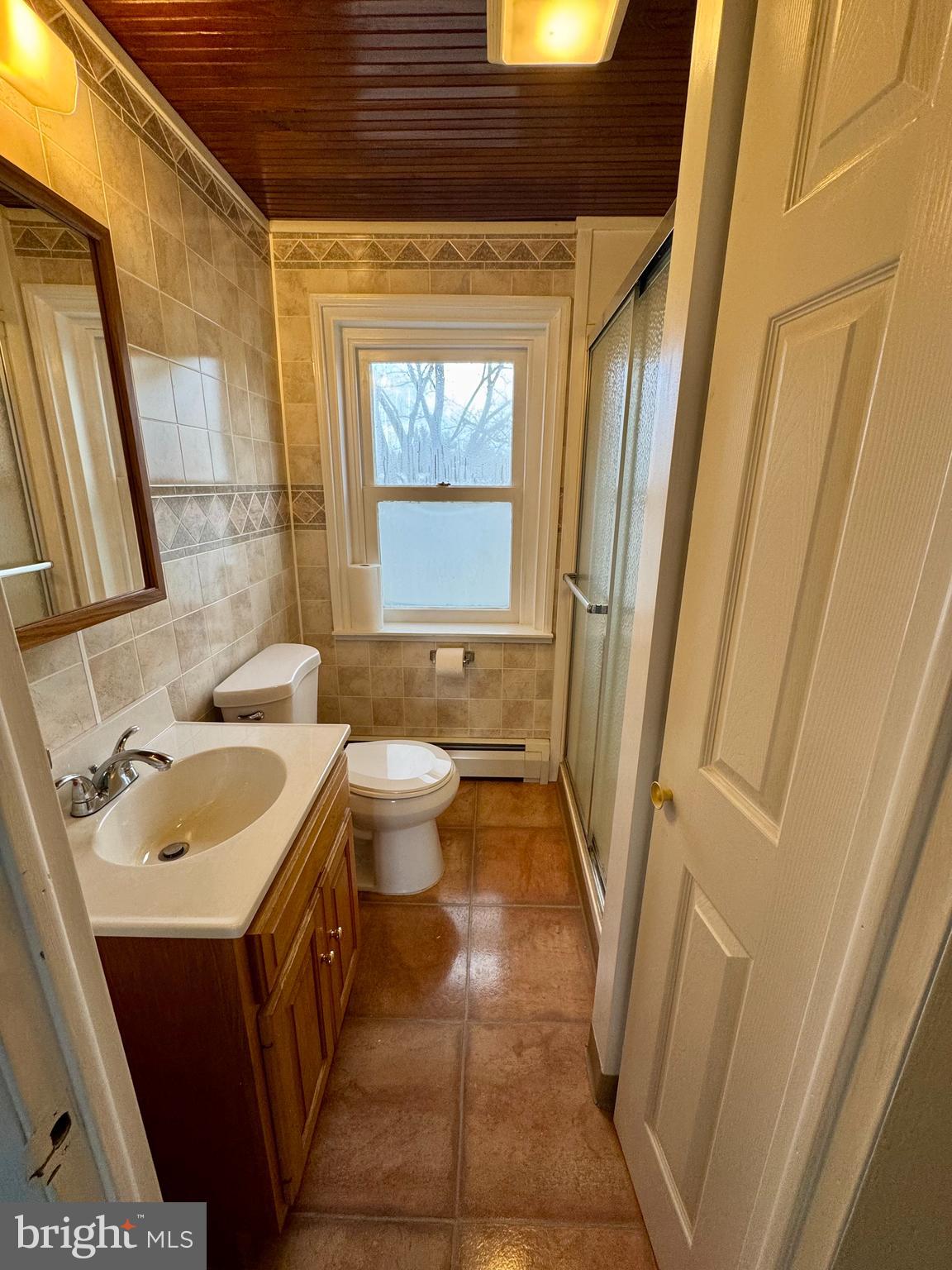 180 Sassamansville Road Gilbertsville, PA 19525 - Photo 15 of 20 a bathroom with a sink a toilet a window and a mirror