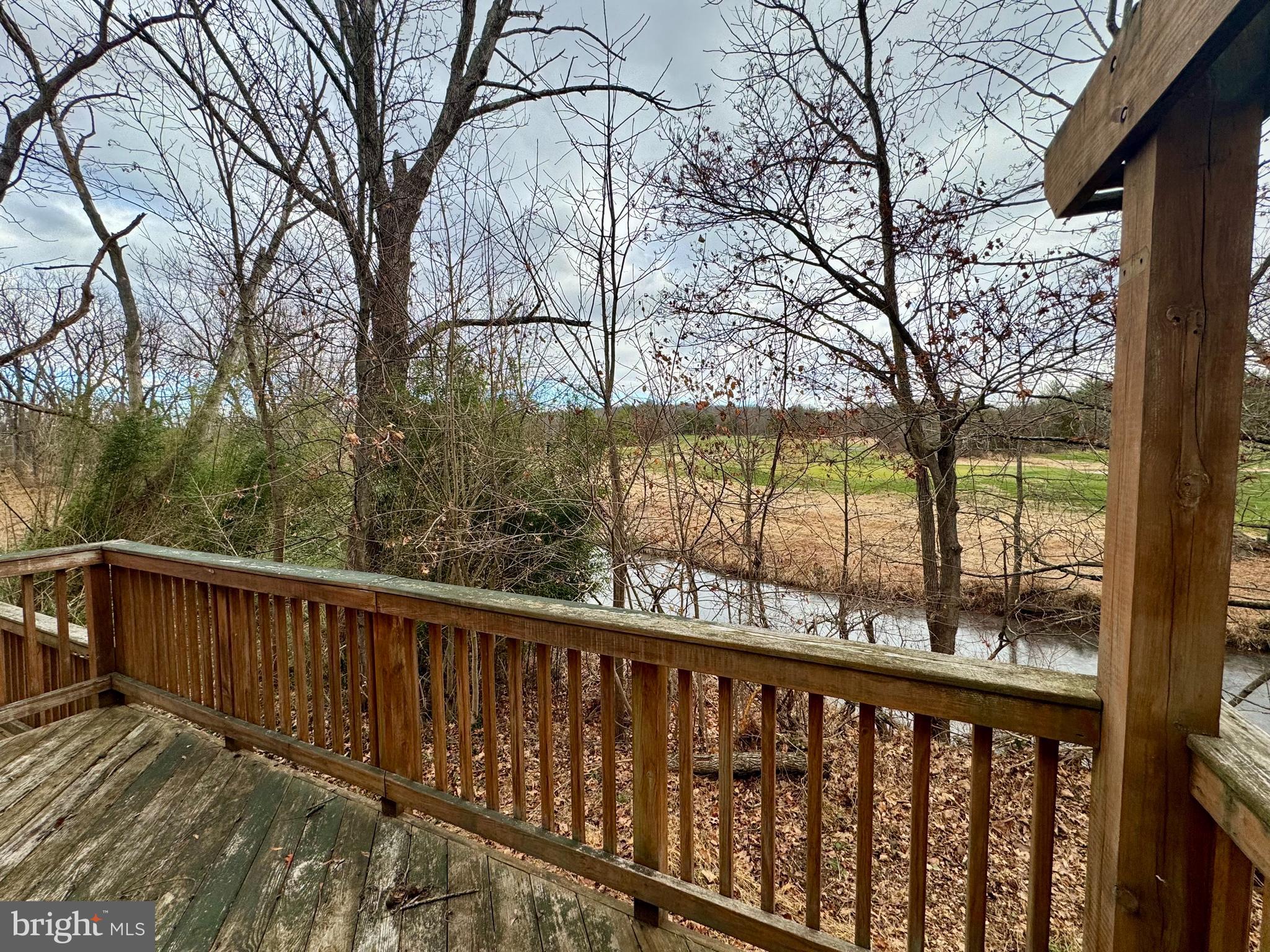 180 Sassamansville Road Gilbertsville, PA 19525 - Photo 17 of 20 a view of a wooden deck next to a yard with large trees