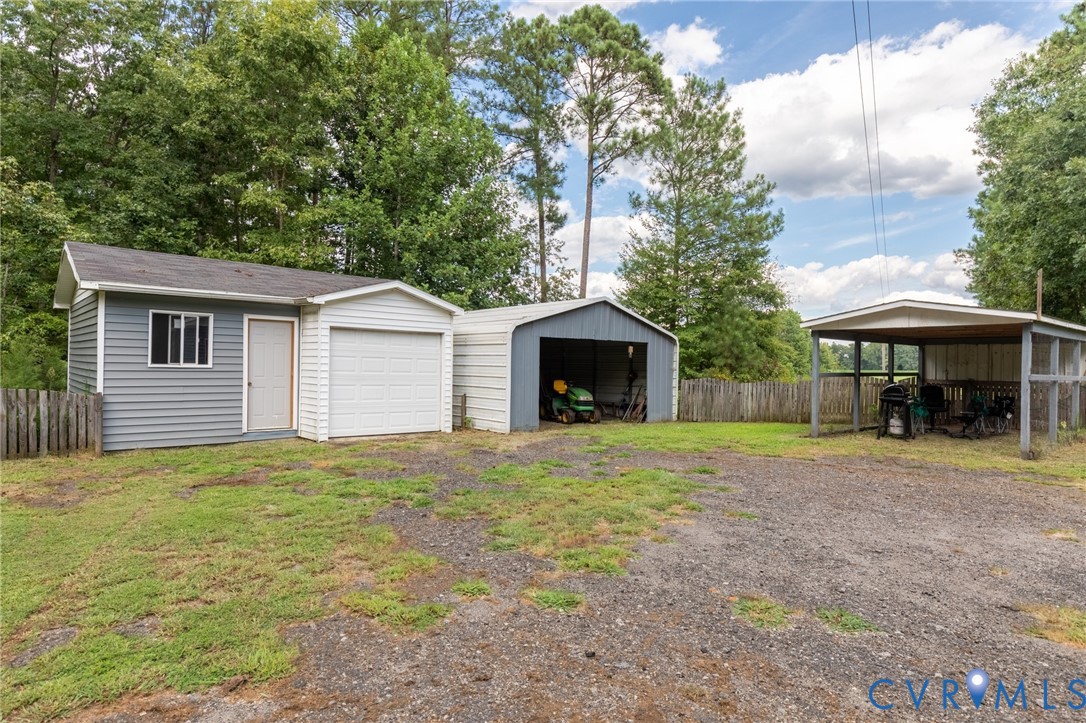 173 Antioch Road Warfield, VA 23889 - Photo 17 of 26 a front view of a house with a yard and trees