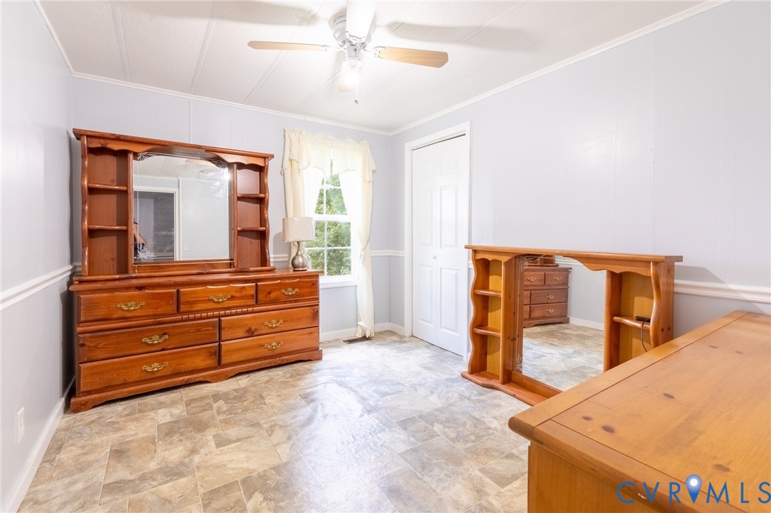 173 Antioch Road Warfield, VA 23889 - Photo 20 of 26 a bedroom with a bed and a dresser
