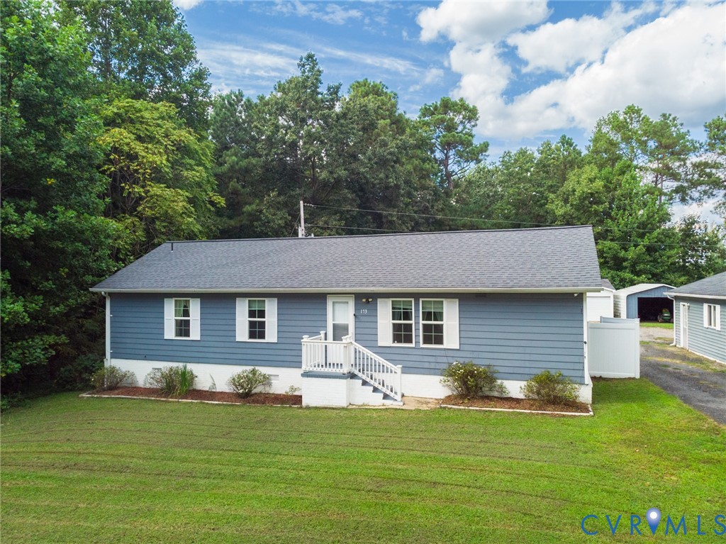 173 Antioch Road Warfield, VA 23889 - Photo 2 of 26 a front view of a house with a garden