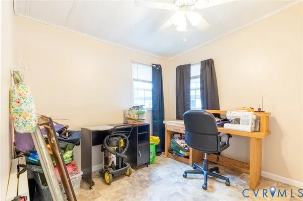a view of a workspace with furniture and a window